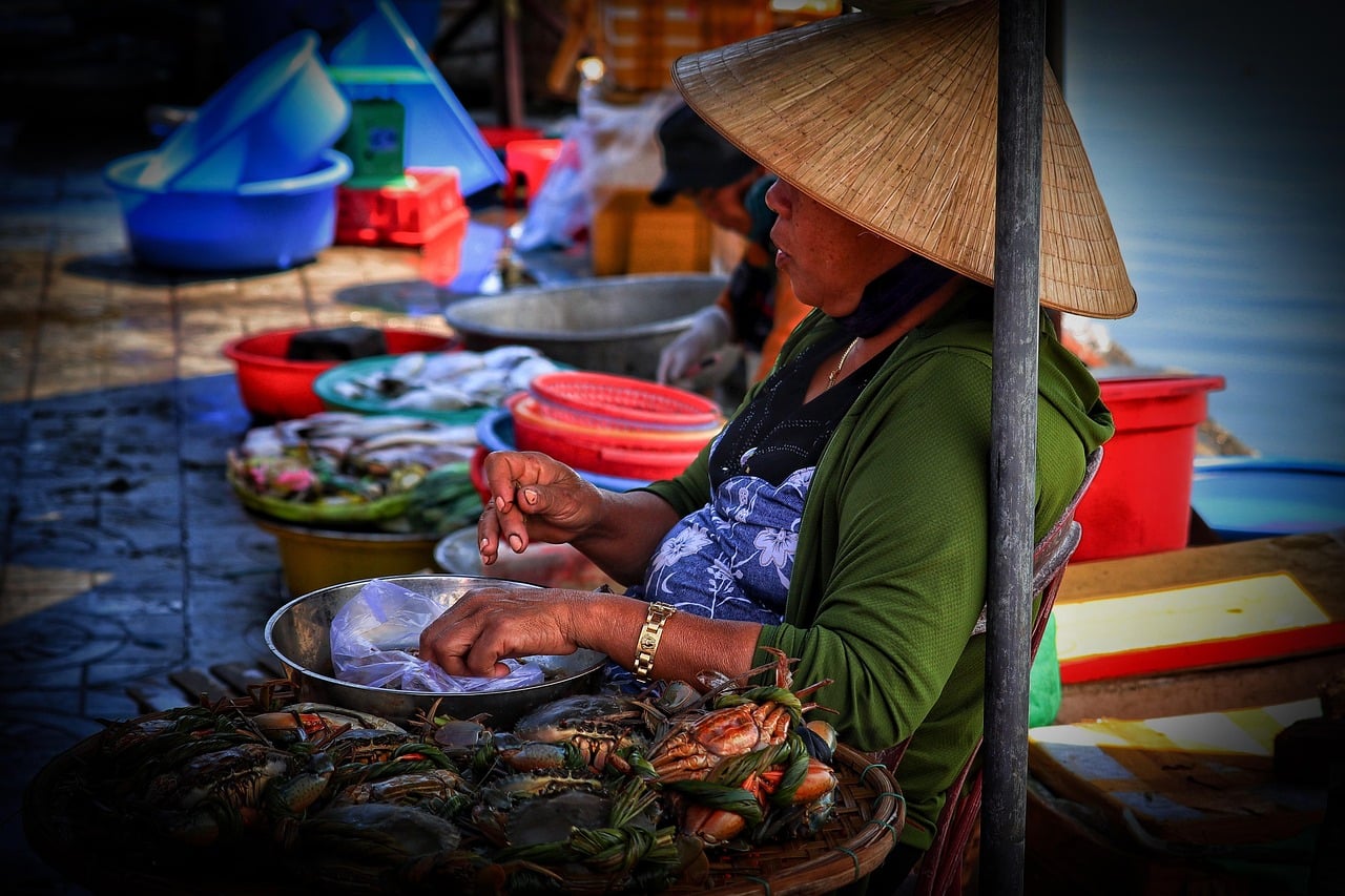 A vendor selling fresh seafood at a Vietnamese market