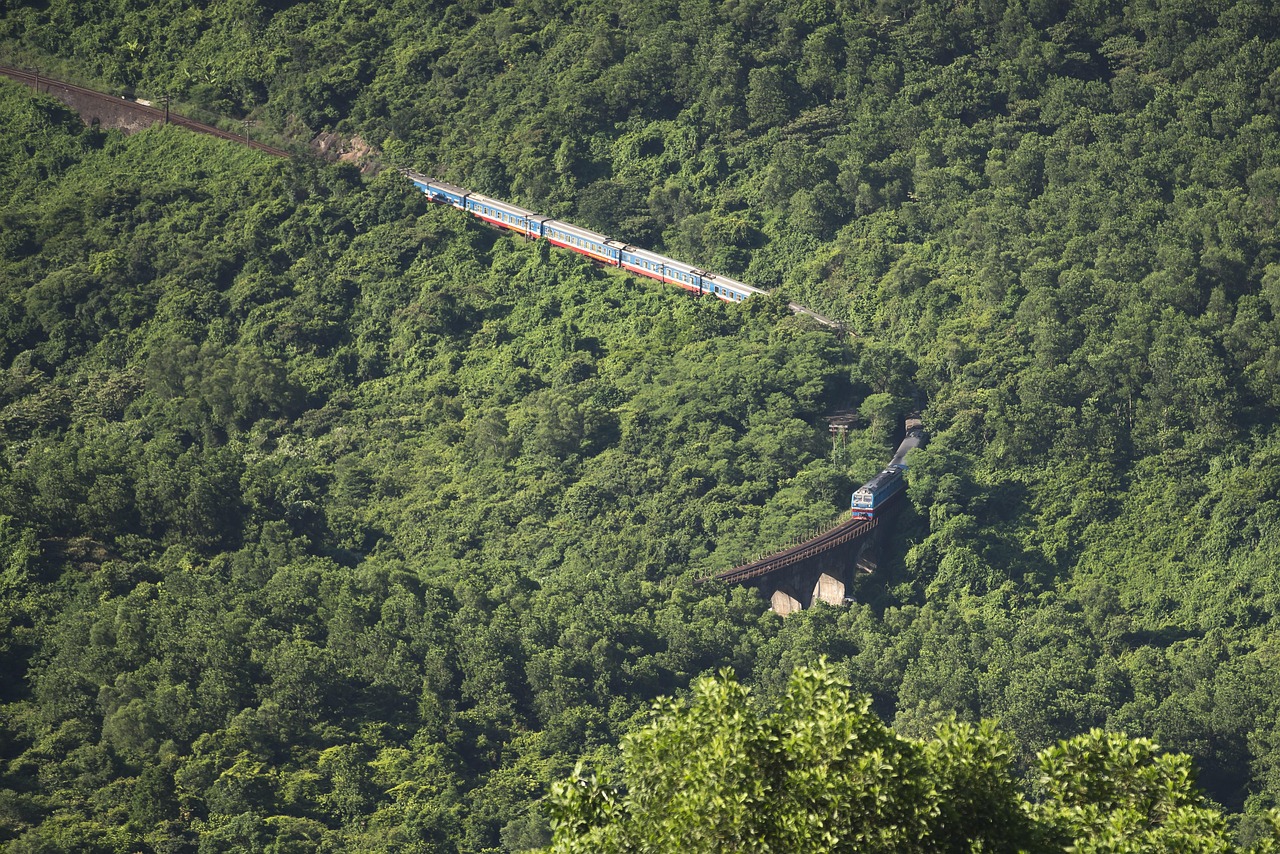 Train hugging the seaward cliffs of the Hai Van Pass railway