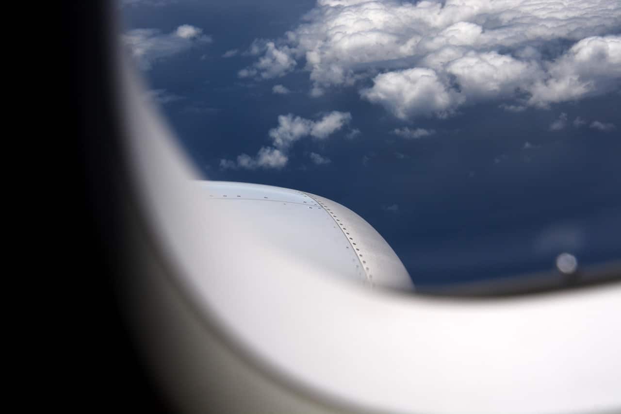 Looking out an airplane window in flight