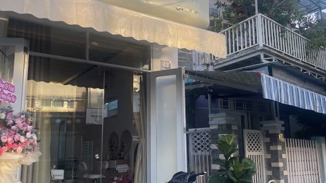Hi Spa storefront with glass doors, a scooter parked outside, and a signboard by the entrance on the sidewalk.