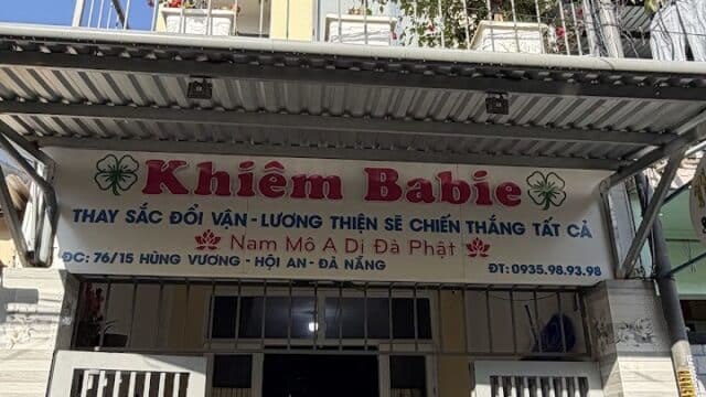 A two-story building with a sign reading Khiem Babie Spa and potted flowers adorning the balcony.