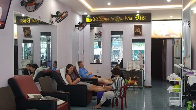 People relaxing and getting pedicures at Mai Dao Spa, a bright, modern spa with a welcoming Welcome to Spa Mai Dao sign.