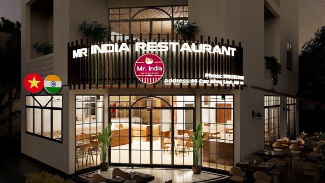 Mr India Restaurant exterior at night, well-lit with large windows, flags, and outdoor seating visible.