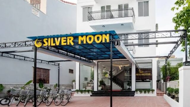 White building with a sign reading Silver Moon Hotel, bikes parked in front, and glass entrance doors.