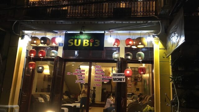 Night view of a massage spa; colorful lanterns hang above, with SUBI3 sign lit above the entrance.