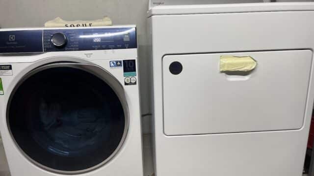 A front-load washing machine beside a top-control dryer brings convenience to your Hoi An laundry room.