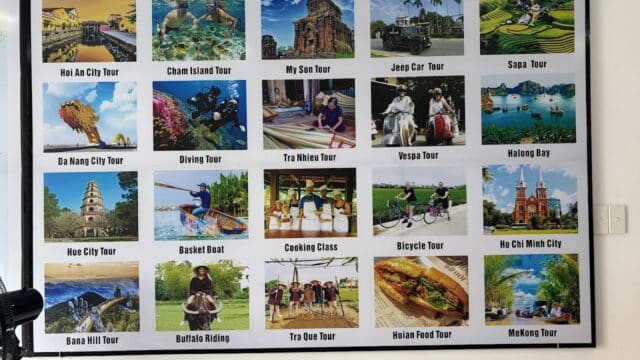 Tour advertisement board with colorful photos and names of various tours in Vietnam, including Hoi An city and nature tours.