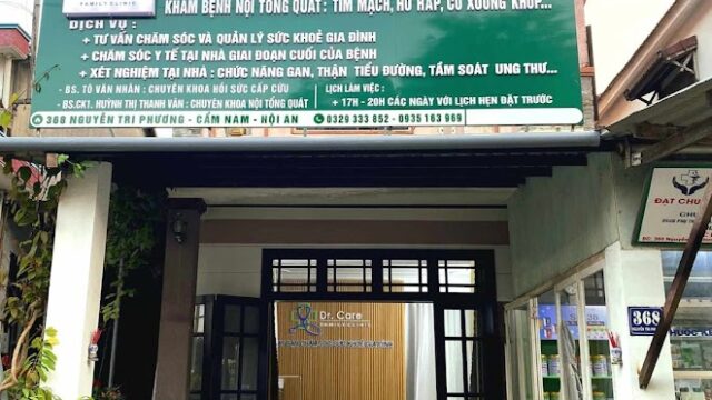 A family medical clinic in Hoi An with a green signboard and open entrance, surrounded by lush plants.