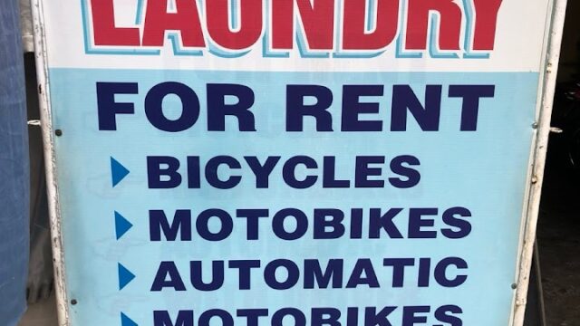 Sign for MRS THANH LAUNDRY in Hoi An offers laundry, bikes, motorbikes for rent, rides to Hue, taxi service, address, and phone number.