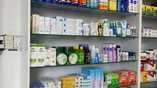 Pharmacy shelves in Hoi An stocked with skincare, toothpaste, soap, and a variety of health and beauty products.